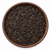 Sfeerbeeld van zwarte Ceylon thee in een rond bakje; originele productverpakking in de galerij