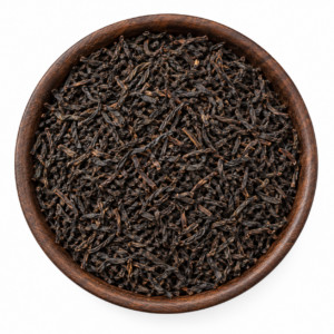Sfeerbeeld van zwarte Ceylon thee in een rond bakje; originele productverpakking in de galerij